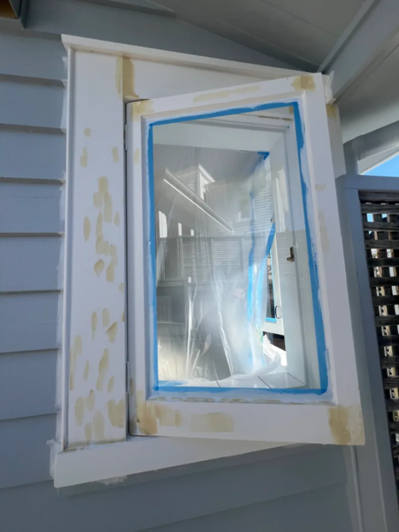 Exterior timber window undergoing filling and surface repairs before painting