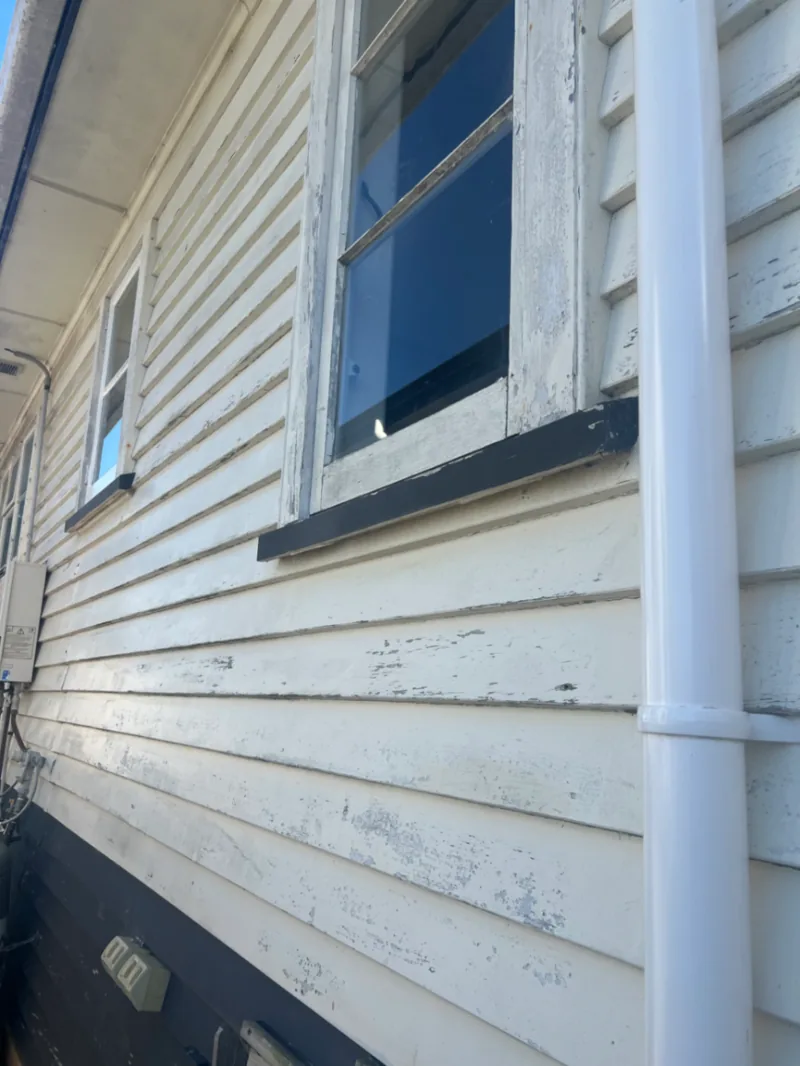 Older timber weatherboards with widespread worn and peeling exterior paint